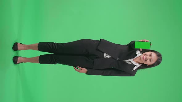 Full Body Of Asian Business Woman With A Smile Showing Green Screen Mobile Phone On Green Screen