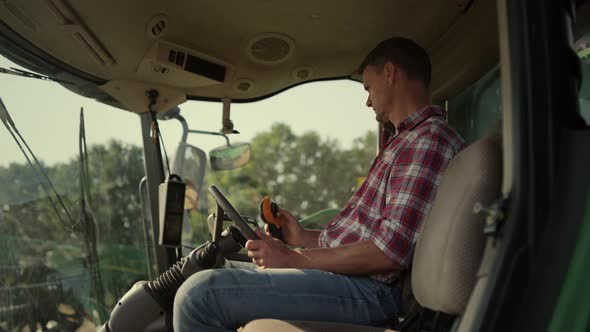 Farmer Working Tractor Cabin at Agricultural Field