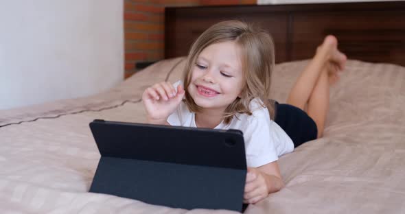 Little Girl Waving Her Hand at Digital Tablet and Communicating Via Video Link  Movie