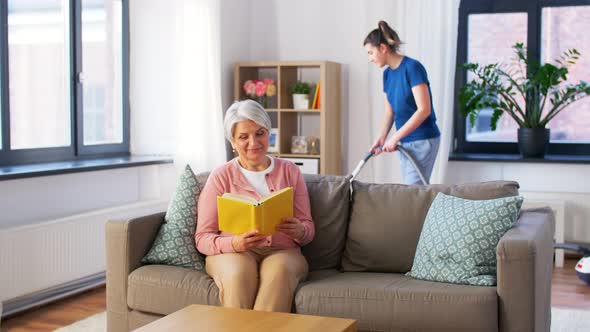 Old Woman Reading Book and Housekeeper at Home