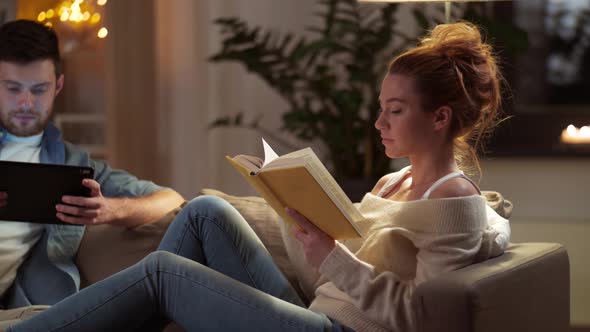 Couple with Tablet Computer and Book at Home 41