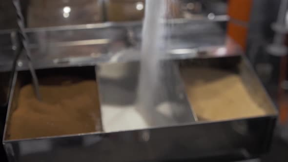 Falling sugar filling stainless container coffee shop cafe barista slow motion shallow depth of fiel