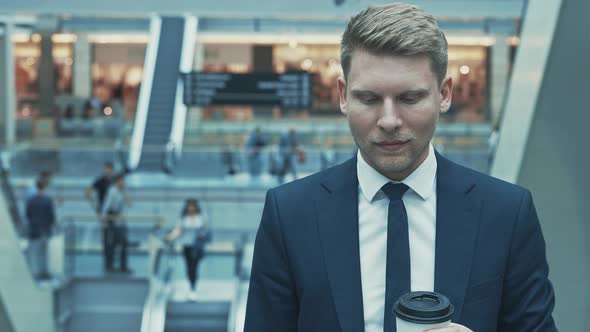 Smiling man drinking a coffee