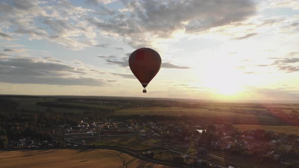 Aerial View: Hot Air Balloon in Sky Over Field in Countryside at Beautiful Sunset