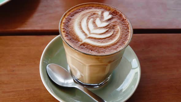 Cup of Cappuccino Coffee on Wooden Table