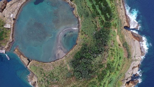 Volcanic crater with blue lake inside. Aerial drone top down flight over, Azores, 4k.