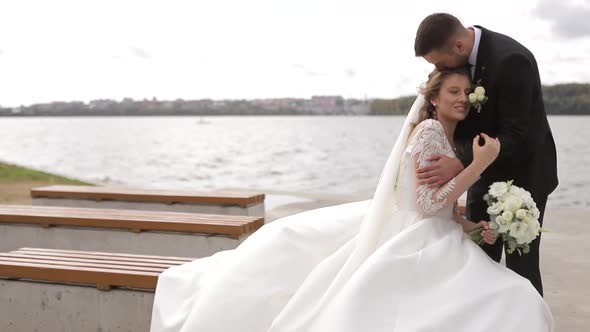 Beautiful Couple in Love Hugging Against the Background of Glowing Lights