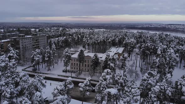 Aerial view of an old soviet school in a small town on a winter day