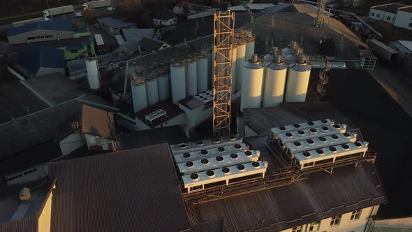 Aerial view of a drone flying over the beer production plant, several rows of tanks. 