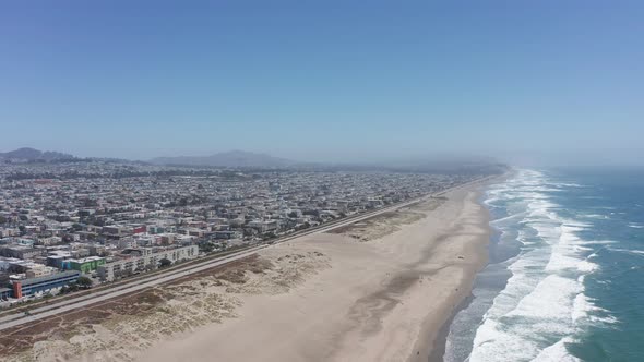 Descending and panning aerial shot of Ocean Beach in San Francisco. 4K