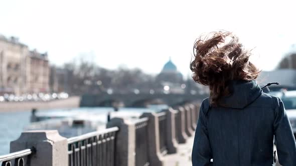 Happy Young Girl With Long Hair Denim Clothes Walking Along the River