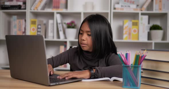 Girl learning online via laptop