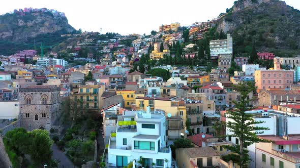 Aerial view on buildings of Taormina, Italy. Drone shot going up, 4k