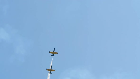 Power Aircraft Fly in a Slender Line, Doing Maneuvers with Smoke at an Air Show