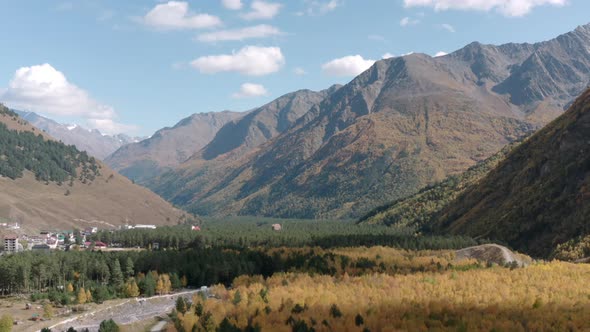 Azau Glade with Autumn Forest and Baksan River at Elbrus Mountain