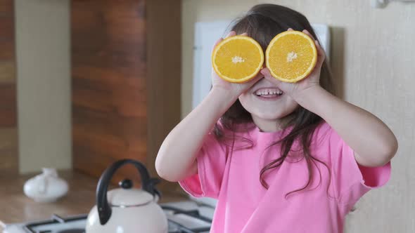 A child is playing with an orange. 