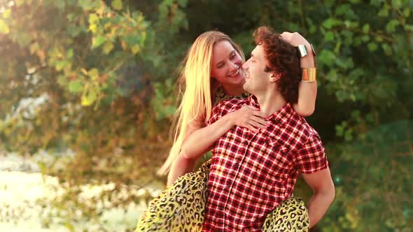 Young man giving his girlfriend a piggyback ride