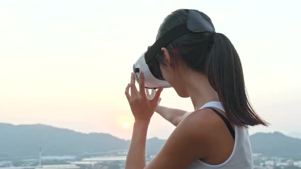 Woman watching with virtual reality device at outdoor 