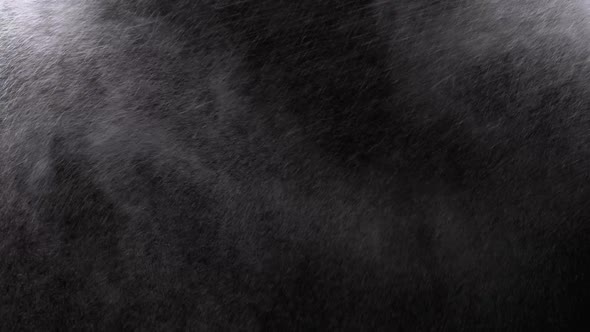 Water Spray Against Black Background. Micro Drops of Water Fly in the Air. Slow Motion alt