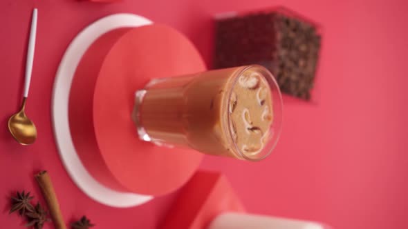 Vertical video: ice latte on red background