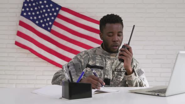 Afro-american Soldier Using Computer and Portable Radio Set