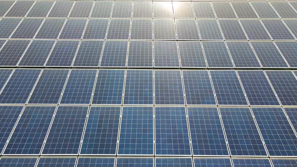 Closeup of Surface of Blue Photovoltaic Solar Panels Mounted on Building Roof for Producing Clean