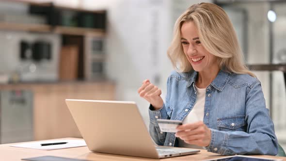 Online Shopping Success on Laptop By Young Casual Woman 