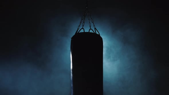 Boxing Pear in the Center of the Frame Smoke Billows From Behind