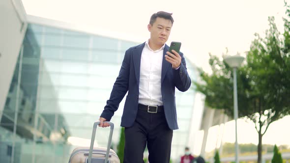 Asian business man standing on the background a modern train station airport