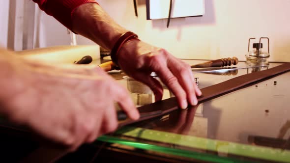 Tailor Cuts the Edge of a Piece of Pressed Leather Before Making It in a Belt