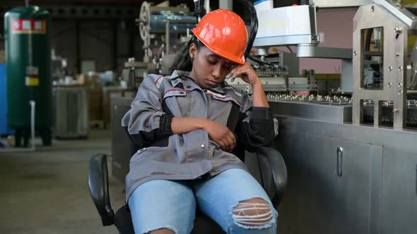 Young black woman sleeping in the workplace, violating safety precautions