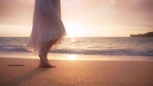 Woman in Beautiful White Dress at Sunset Slow Motion Woman Feet Walking By Beach