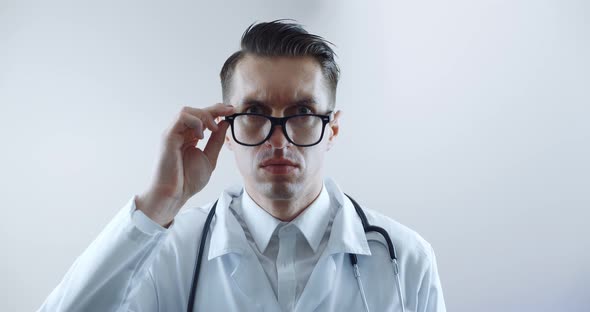 Portrait of Shocked Doctor Man is Surprised and Takes Off His Glasses in Shock and Looks at the