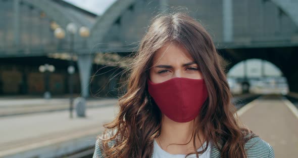 Close Up View of Brunette Woman in Cotton Protective Face Mask Standing at Railway Station. Portrait