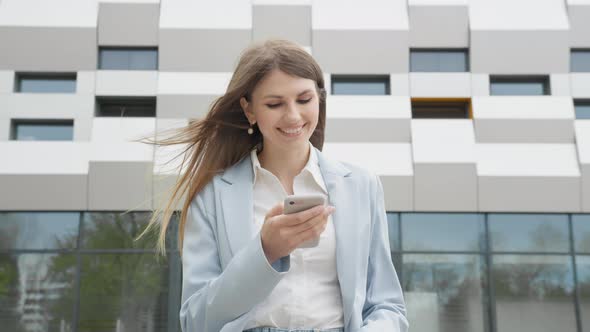 Adult Caucasian Confident Young Business Woman in White Shirt is Enjoys on Phone