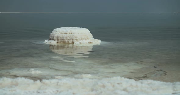 Tracking shot of salt deposits on the banks of the Dead Sea in israel