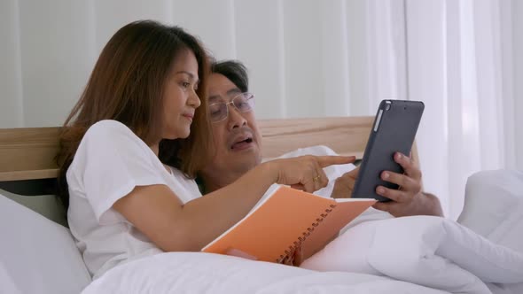 Happy Asian senior couple spending time together at home