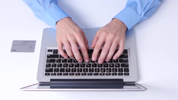 Man Buying with Credit Card, Using Laptop Computer. Close Up