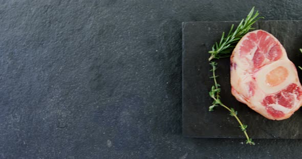 Sirloin chops and rosemary on chopping board