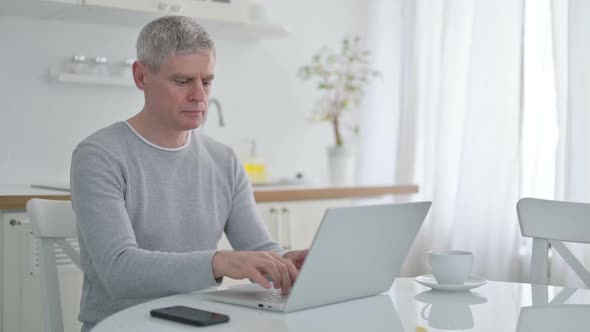 Senior Old Man with Laptop Showing No Sign with Finger