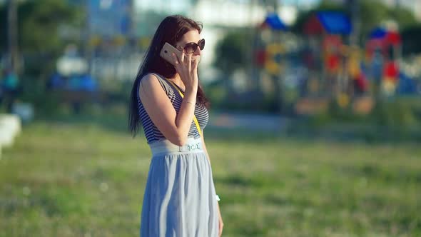 Young Beautiful Smiling Woman Talking on Cell Phone