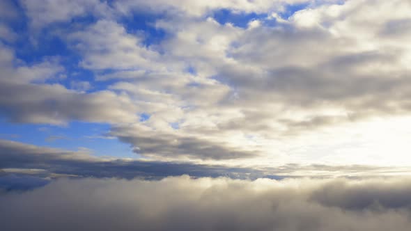 Aerial view up from the clouds to the sky in motion. Aerial view white clouds in blue sky 