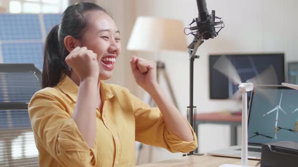 Close Up Of Asian Woman Being Happy Succeed Testing The Wind Turbine While Working With Laptop