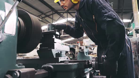 Smart Factory Worker Using Machine in Factory Workshop