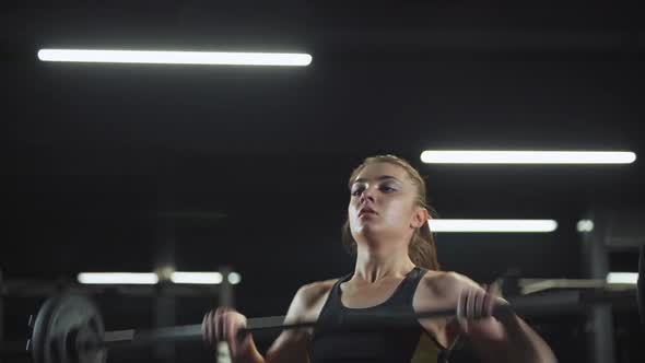 Strong Woman Athletic Female Performs Exercises with Barbell Lifts Barbell and Does Weights Crossfit