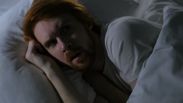 Redhead Man Using Smartphone, in Bed Browsing