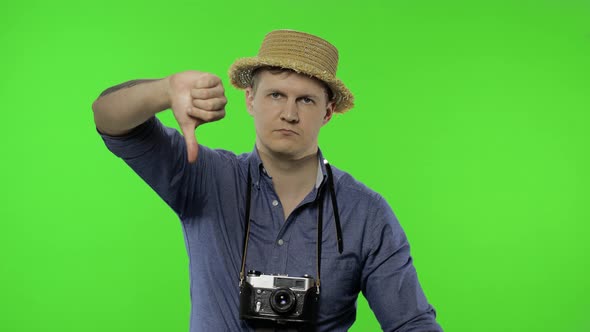 Portrait of Young Man Tourist Photographer Giving Thumbs Down. Chroma Key