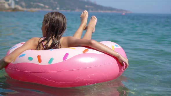 Adorable Girl on Inflatable Air Mattress in the Sea