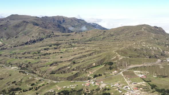 Aerial view that slowly flies over an agricultural landscape up in the andean mountains