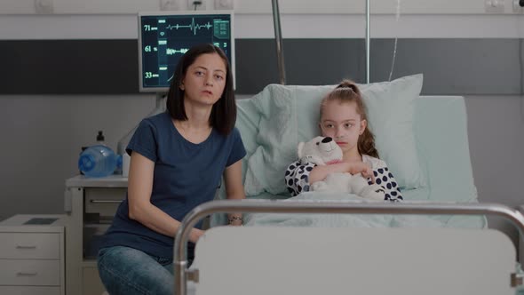 Pov of Mother Sitting Beside Daughter Discussing Medical Recovery Treatment with Remote Father